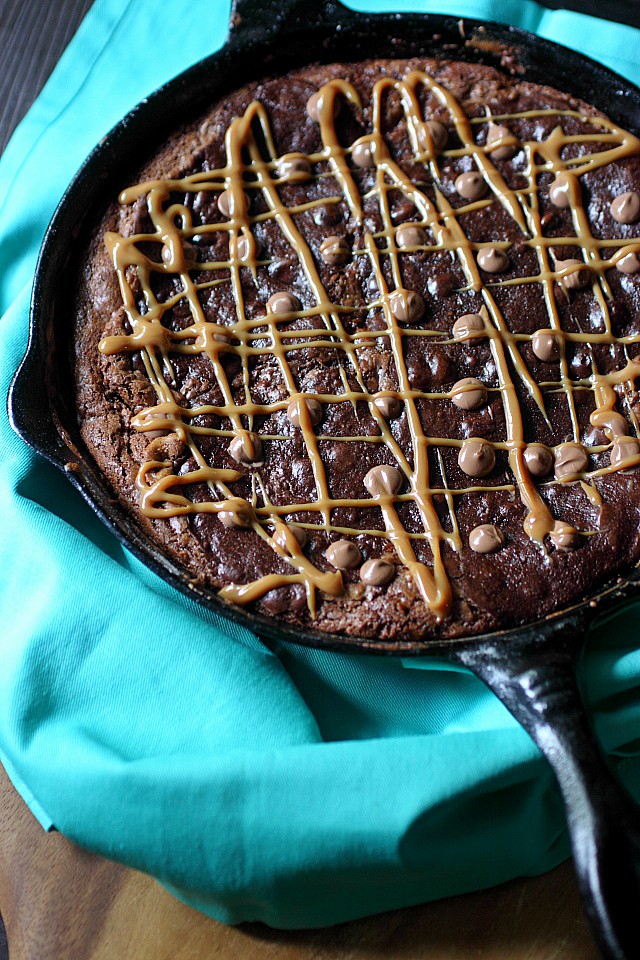 A dark chocolate chip brownie layer sits atop a sweetened flaked coconut chocolate chip cookie layer in this Brookie Skillet Cookie. Left slightly under baked and served with vanilla ice cream - This Brookie Skillet Cookie is a gooey treat to enjoy repeatedly and often! -- mind-over-batter.com