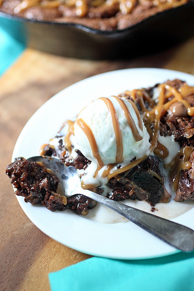 A dark chocolate chip brownie layer sits atop a sweetened flaked coconut chocolate chip cookie layer in this Brookie Skillet Cookie. Left slightly under baked and served with vanilla ice cream - This Brookie Skillet Cookie is a gooey treat to enjoy repeatedly and often! -- mind-over-batter.com