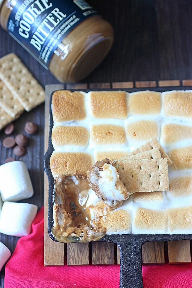 With this Cookie Butter S'mores Dip, you won't need to go camping to enjoy s'mores! Cookie butter is melted with rich milk chocolate and sweet marshmallows to create this seriously addicting dip! Grab your graham crackers and enjoy s’mores any time!  www.mind-over-batter.com