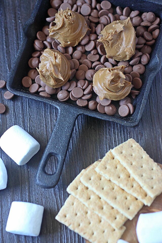 With this Cookie Butter S'mores Dip, you won't need to go camping to enjoy s'mores! Cookie butter is melted with rich milk chocolate and sweet marshmallows to create this seriously addicting dip! Grab your graham crackers and enjoy s’mores any time!  www.mind-over-batter.com