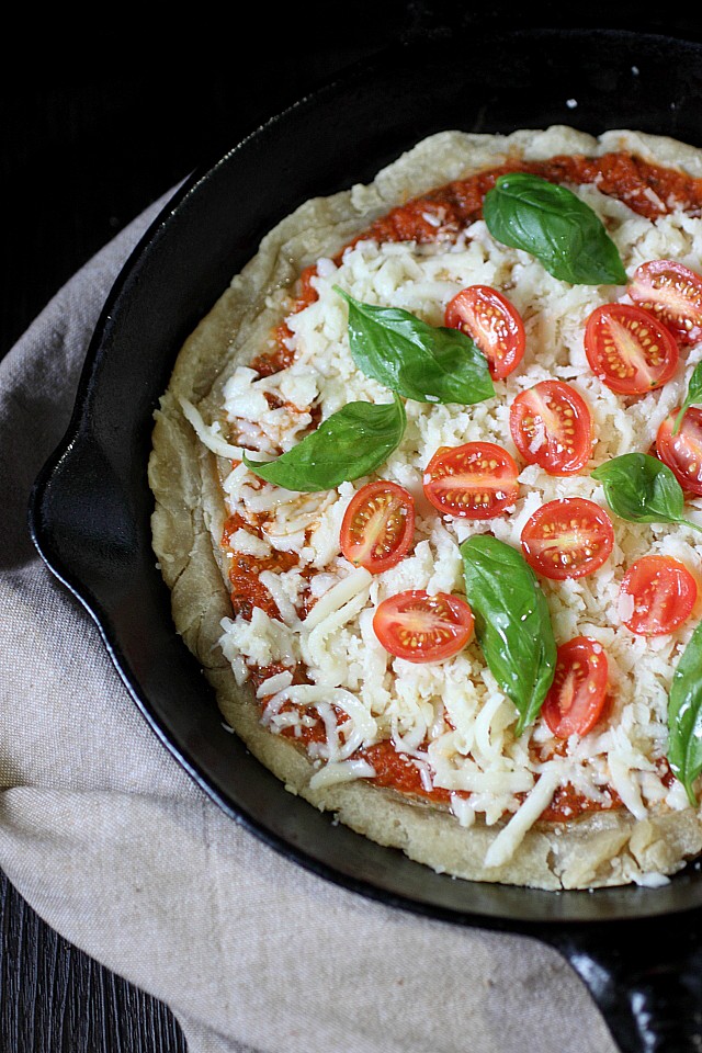 The classic Pizza Margherita.... In a skillet! This lip-smacking thin crust pizza is adorned with a quick homemade tomato sauce, chewy mozzarella cheese combined with a bit of nutty Parmesan, fresh basil, and grape tomatoes. Pizza night  just got tastier! www.mind-over-batter.com